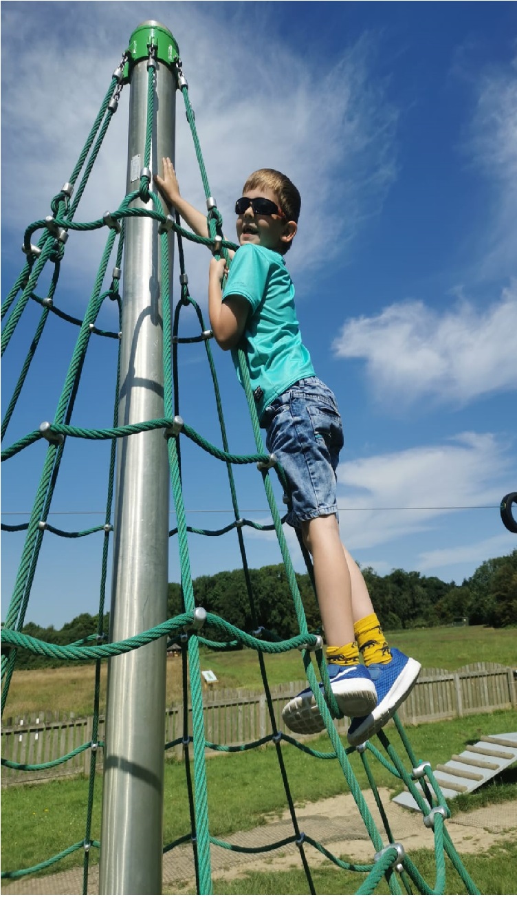 Grandson having fun climbing in the park